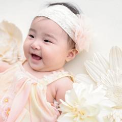 お花に囲まれて笑う赤ちゃん