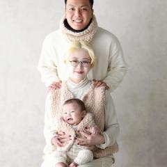 お揃いで白い服を着ている家族写真