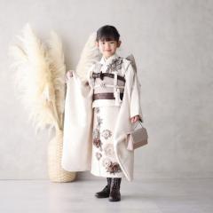 七五三の着物を着て袖を広げて立っているおんなのこ