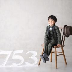 タキシードをきて椅子に座っているおとこのこ